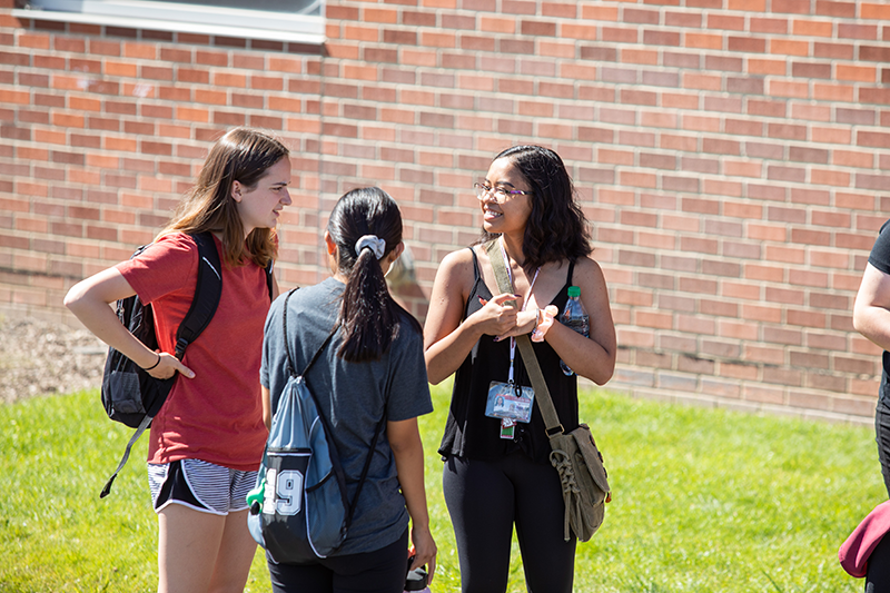 three students talk outside of the SRC